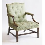 A George III mahogany Gainsborough or library chair,upholstered in green damask, the downswept