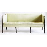 A George III mahogany three-seat settee,upholstered in green silk with a squab cushion, with