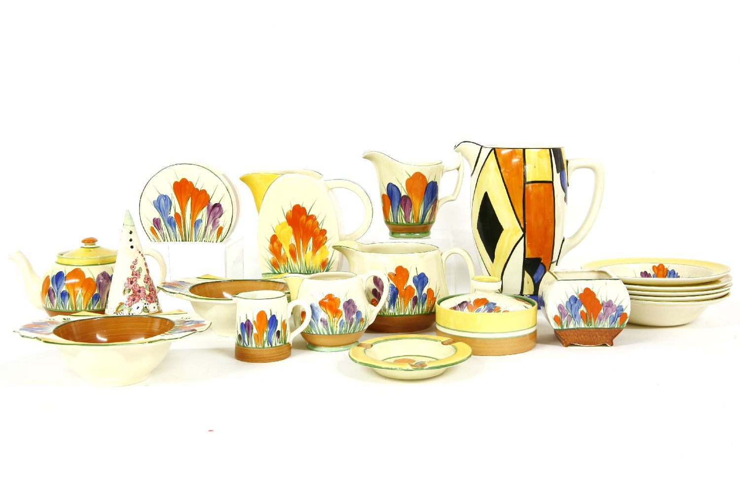 Clarice Cliff, a restored jug, 'Crocus' pattern items, a teapot, bowl and cover, ashtray, jugs,