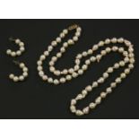 A single row uniform cultured baroque pearl necklace, with gold clasp, marked 375, and a pair of