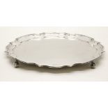 A large silver tray, with pie crust edge on scroll feet, by Alexander Clark & Co Ltd, Sheffield,