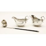 A pair of Asprey silver sauce boats, 14.5cm wide, and a Georgian silver and whalebone handle