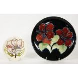 A 20th century Moorcroft plate, decorated with hibiscus flowers, 22cm diameter, together with a