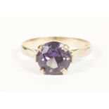 An Egyptian gold synthetic colour change sapphire ring, (tested as 9ct gold)2.78g