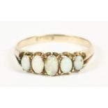 An Edwardian 15ct gold five stone opal cabochon ring, claw set to a plain polished shank, damage