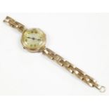 A ladies 9ct gold mechanical bracelet watch, dated possibly 1919, with silvered dial and Arabic