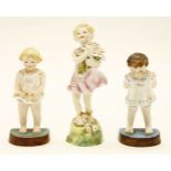A Royal Worcester F G Doughty porcelain figure,figure of a young girl holding a bunch of flowers,