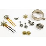 A collection of items to include a sterling silver hinge bangle, with gold faced swallows,