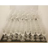 A large suite of modern glassware, to include champagne flutes and large wine glasses, each with