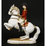 A Vienna porcelain figure of a Spanish Riding School horse and rider, damage to ear, 23cm high