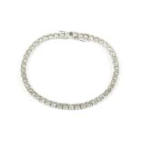 A white gold diamond set line bracelet, with a stated total diamond weight of 7.00ct, marked 750,