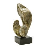 A mottled stone sculpture of shaped abstract form by Dace Lielausis, on an ebonised plinth, height