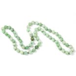 A single row circular jade bead necklace, strung knotted