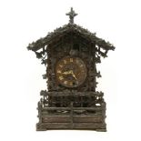 A large carved wooden black forest cuckoo clock, with three train movement and two birds, 60cm high