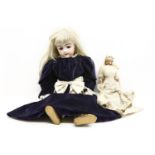A Victorian bisque head doll, clothed with open mouth and sleeping eyes, 74cm high and a wax head