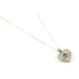 A gold pave set diamond heart shaped pendant, with a scintillating bracelet, diamond claw set at the