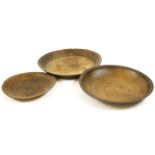 Three large wooden bowls, largest diameter 68 cm