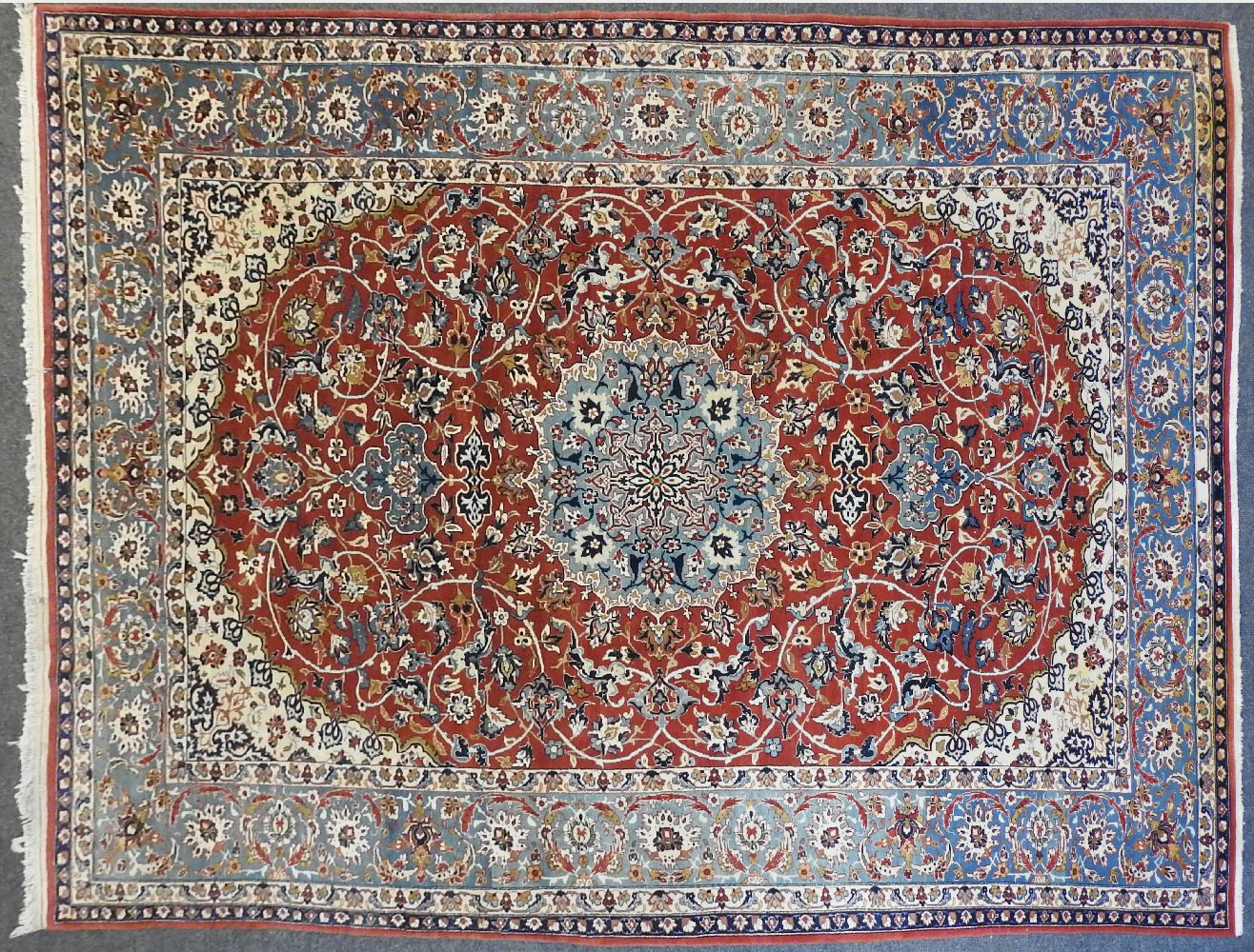 An Isfahan rug, decorated all over with a floral design to a red ground, 300cm x 200cmProvenance: