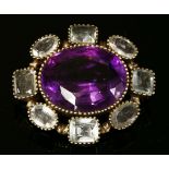 A Victorian silver gilt amethyst and aquamarine brooch, with an oval mixed cut amethyst set to the