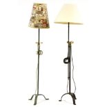 Two iron standard lamps, one with adjustable height, with shades