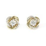 A pair of gold single stone diamond stud earrings, with a pair of detachable diamond set jackets,