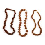 Two single row freeform amber chip bead necklace, and a single row pressed early plastic bead