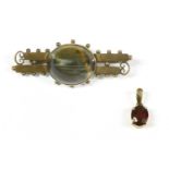 A late Victorian Continental gold single stone hawk's eye two row bar brooch, with a bead border,