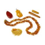 A single row freeform amber bead necklace, strung knotted to a lobster claw clasp, a free form amber