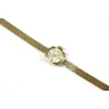 A ladies 9ct Uno mechanical bracelet watch, silvered dial with gilt baton markers, brick link
