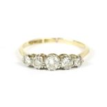 A gold five stone graduated diamond ring, marked 18ct and P, split to shank, approximate size N, 2.