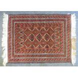 A hand knotted Bokhara rug, the red fields within geometric multi-border, 76 x 100cm