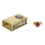 A 9ct gold single stone red paste signet ring, and a gilt metal William Ogode matchbox case,