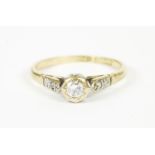 A gold single stone diamond ring, with diamond set shoulders, size L1.93g, and a rolled gold open