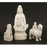 A group of Chinese blanc de Chine,18th century, a figure of Guanyin seated on a rock with a boy on