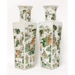 A pair of Chinese famille verte vases,1850-1860, each with a tapered square section body, painted