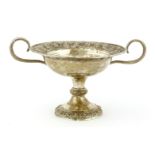 An Indian silver tazza, of circular form on a circular base, the border with impressed deities,