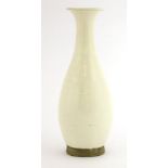 A Chinese white-glazed vase,Song dynasty (960-1279), the pear shaped body on a circular base with an