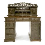 A Chinese twin pedestal desk,early 20th century, the gallery pierced and carved with Buddhist lions,