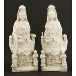 Two Chinese blanc de Chine figures,18th century, of Guanyin, each seated on a rock with a vase and