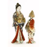 Two Japanese bijin,Meiji period (1868-1912), one wearing a blue kimono decorated with blossoming