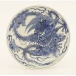 A Chinese blue and white dish,Yongzheng (1723-1735), painted with a dragon grasping a flaming