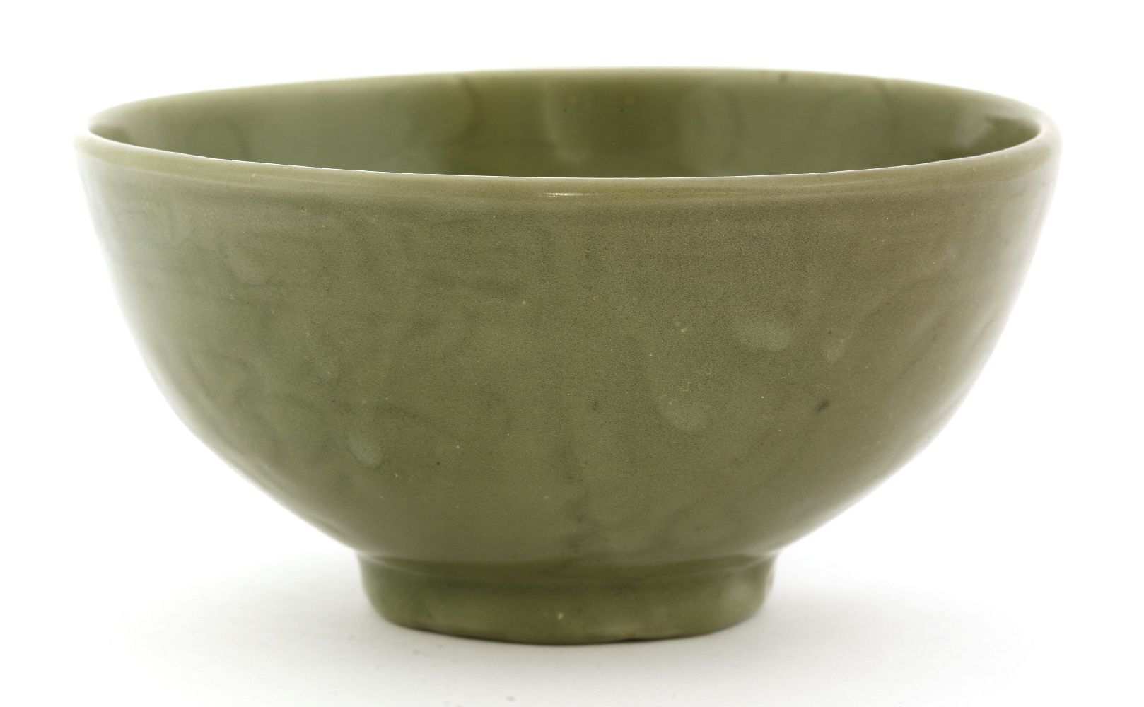 A Chinese celadon bowl,Yuan-Ming dynasty, of circular form on a circular base, the thick potted body