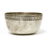 A Thai silver bowl,19th century, of circular form on a flat base, the plain body with a stylised