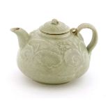 A Chinese Qingbai teapot and cover,Northern Song (960-1127), of squashed globular shape, with