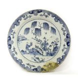 A Chinese blue and white charger, Qianlong (1736-1795), painted with a boy presenting a basket of