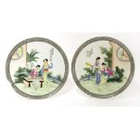 A pair of Chinese famille rose plates, early 20th century, each painted with ladies reading books or