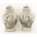 A pair of Chinese famille rose vases and covers,c.1900, each of baluster form, painted with