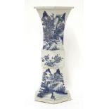 A Chinese blue and white gu vase,19th century, of hexagonal form, painted with a mountainous