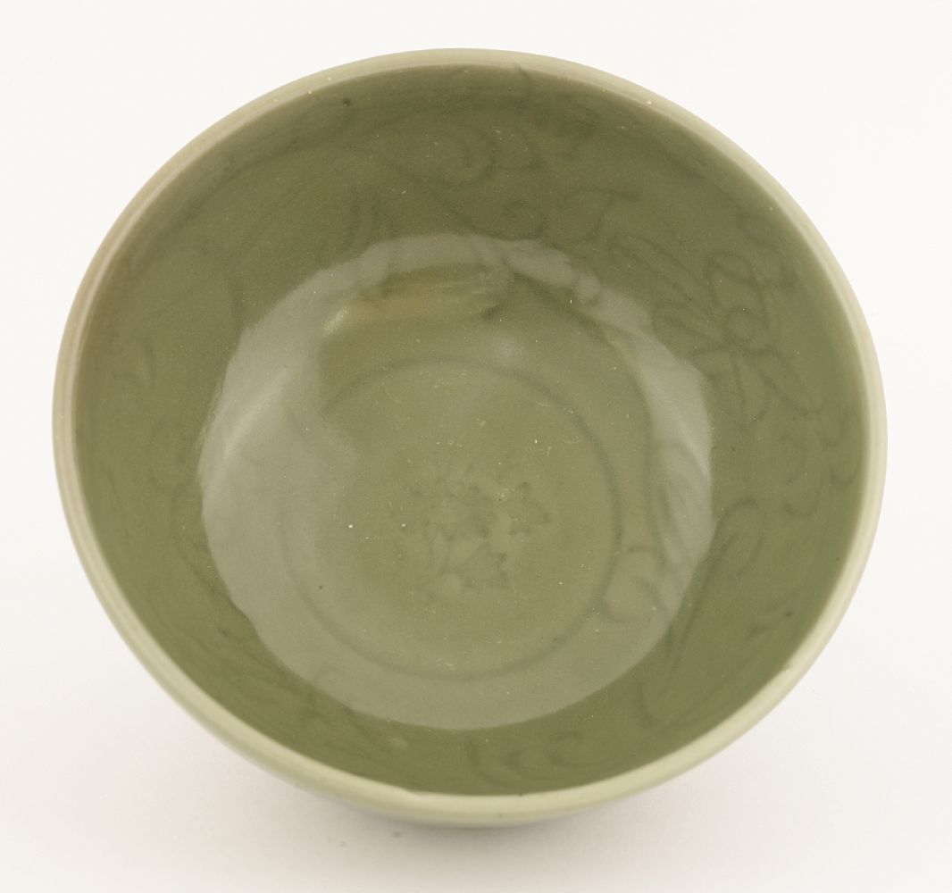 A Chinese celadon bowl,Yuan-Ming dynasty, of circular form on a circular base, the thick potted body - Image 2 of 2