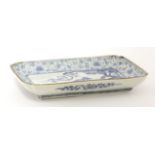 A Japanese blue and white dish,c.1690-1720, of shaped rectangular form, painted with bamboo and